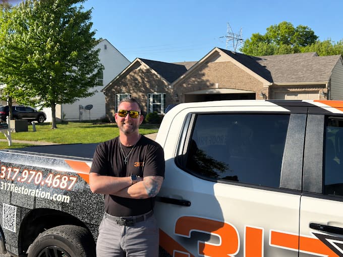 David Denton, founder of 317 Restoration, with the 317 Restoration truck in Indianapolis