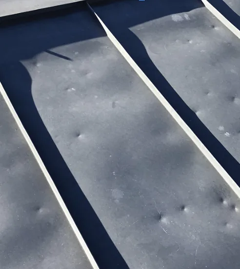 Close-up of a standing-seam metal roof panel and rib detail